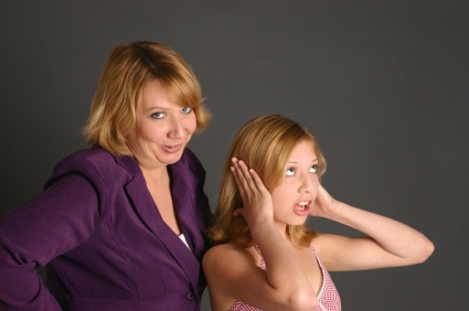 Mother sternly admonishes rebellious blond teenage girl