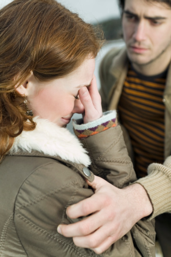 Crying woman with concerned man