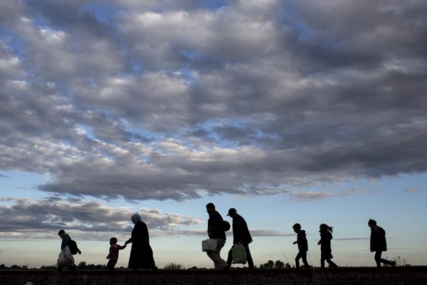 Migrants walk along rail tracks as they arrive to a collection point in the village of Roszke, Hungary, September 6, 2015, after crossing the border from Serbia. Thousands of refugees and migrants streamed into Germany on Sunday, many traveling through Austria from Hungary where they had been stranded against their will for days, while European Union governments argue over how to respond. REUTERS/Marko Djurica TPX IMAGES OF THE DAY
