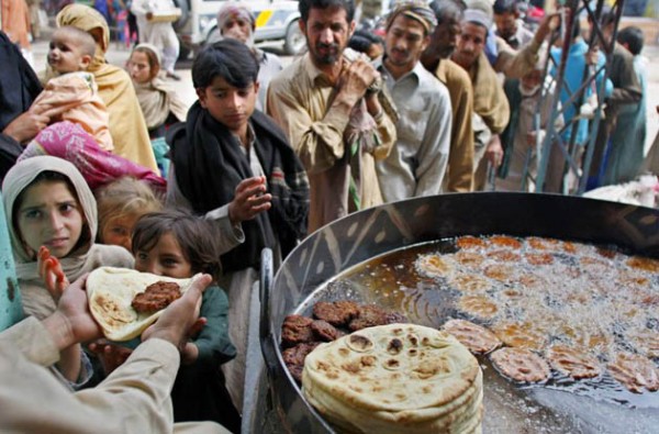 Pakistani poor people get free food from a restaurant in Rawalpindi, Pakistan on Monday, April 7, 2008. According to the World Food Programme (WFP) survey nearly half of Pakistan s 160 million people are at the risk of facing food shortage due to an increase in food prices. The WFP survey shows that the number of people who are food insecure has risen 28 percent to 77 million from 60 million last year. (AP Photo/Anjum Naveed)