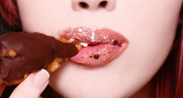woman-eating-chocolate-doughnut-by-Healthista.com_